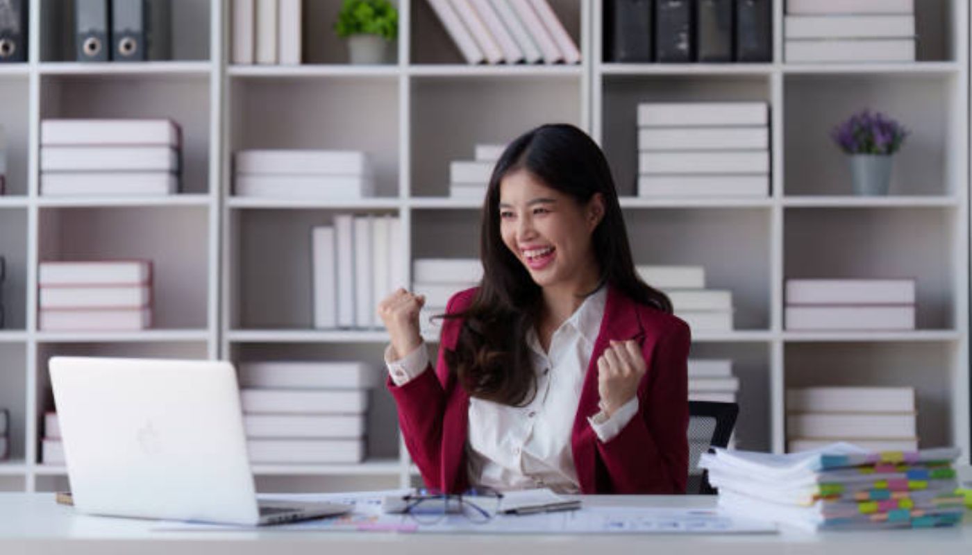 Happy woman cheering excited after a good news