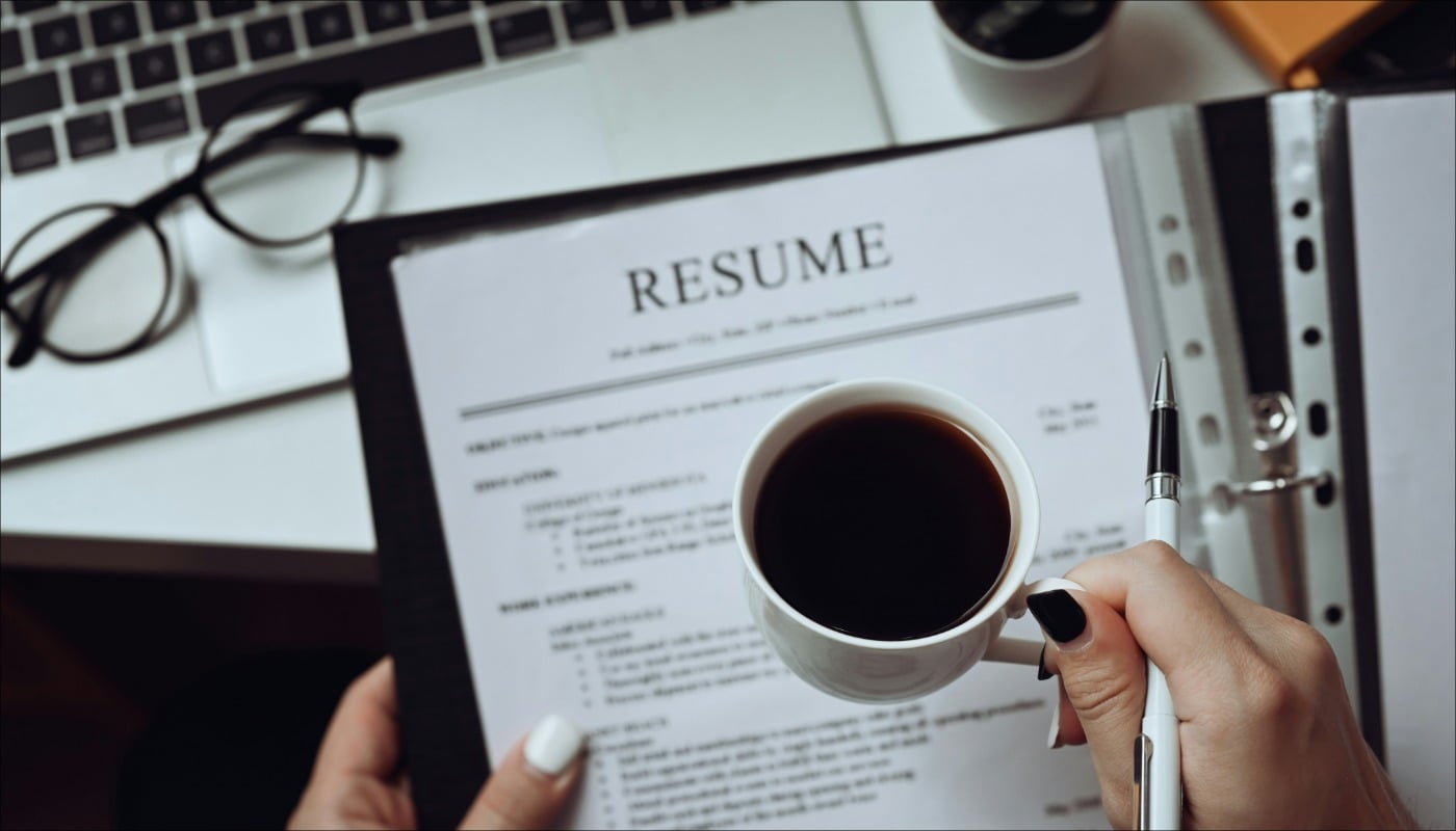 HR manager reading CV resumes of a job candidate.